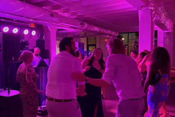 Wedding guests dancing under event lighting at a Rondosound-produced reception