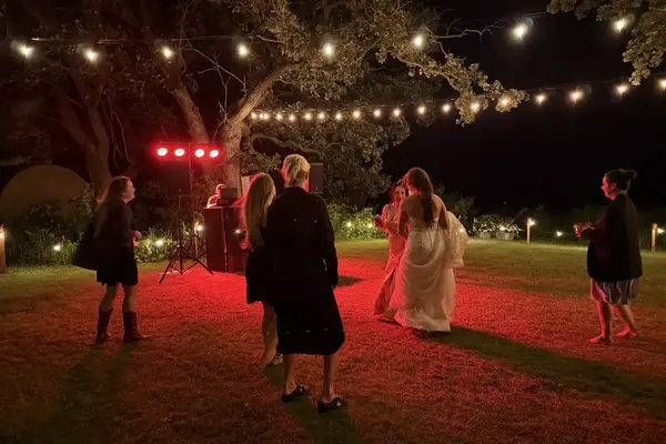 Outdoor wedding sound system rental with string lights at night