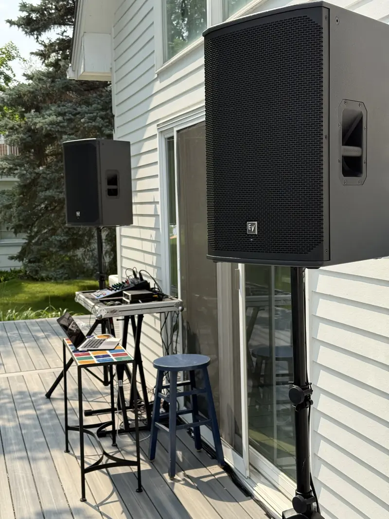 Outdoor speaker rental and DJ setup on a patio deck
