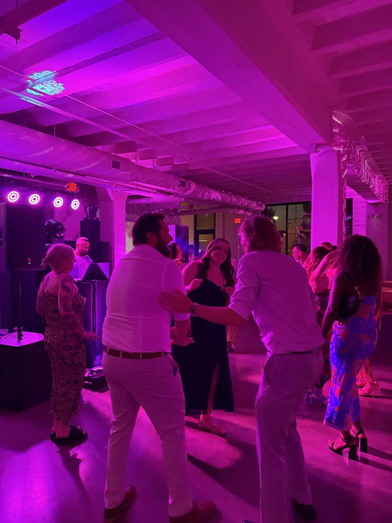 Wedding guests dancing with purple LED event lighting