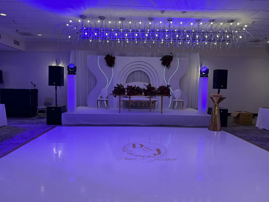 Elegant wedding reception with speakers, uplighting and white dance floor