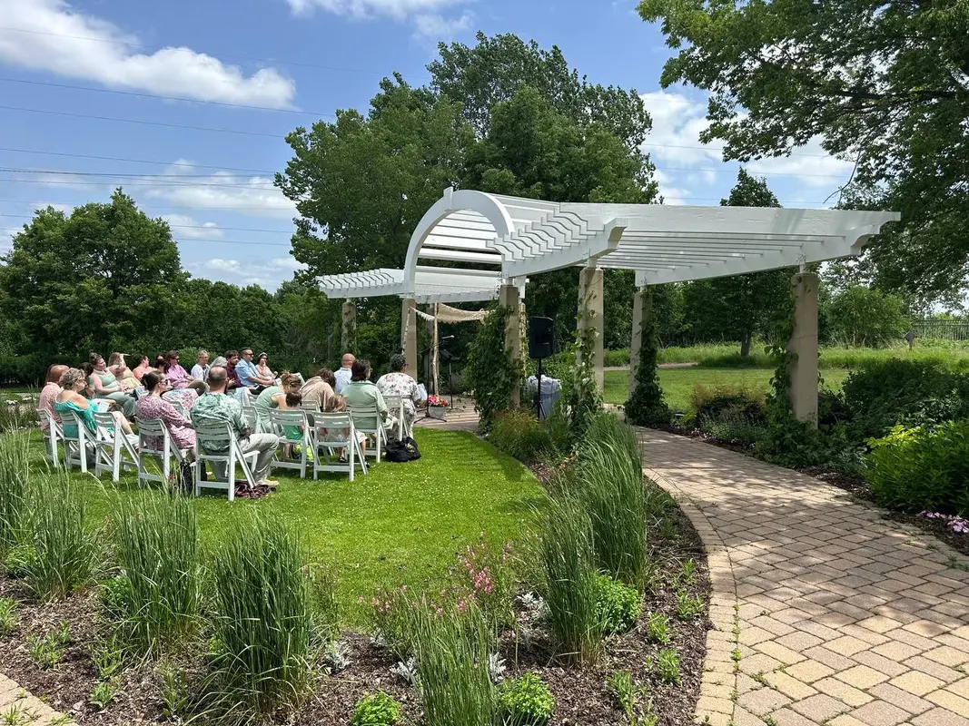Outdoor wedding ceremony at a garden venue with speaker rental